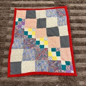 Handmade patchwork quilt on red fleece
